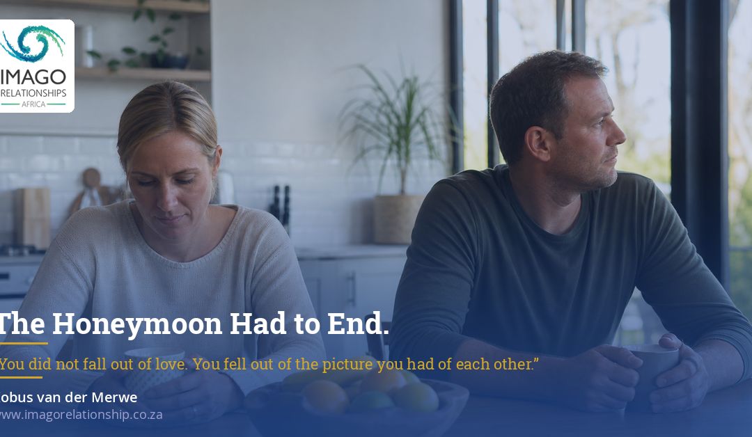 Couple sitting apart at a kitchen counter, looking away from each other.